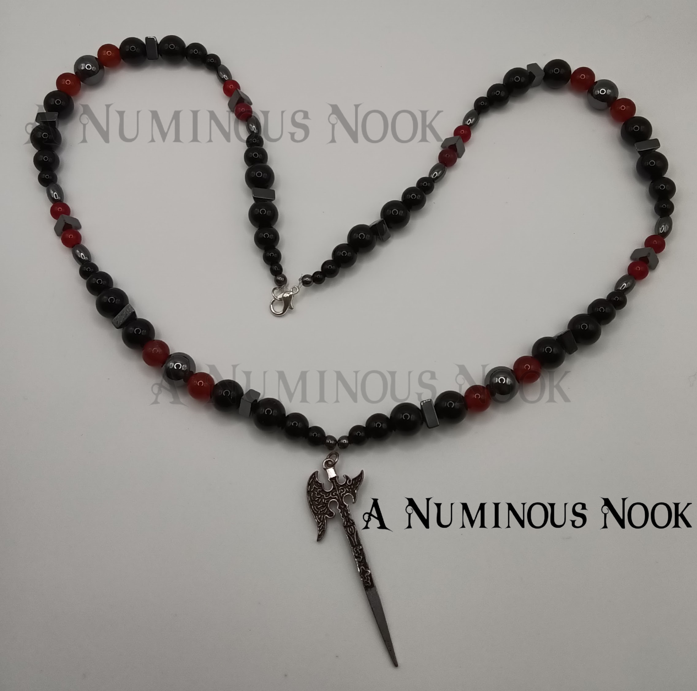 Carnelian, onyx, and hematite axe necklace