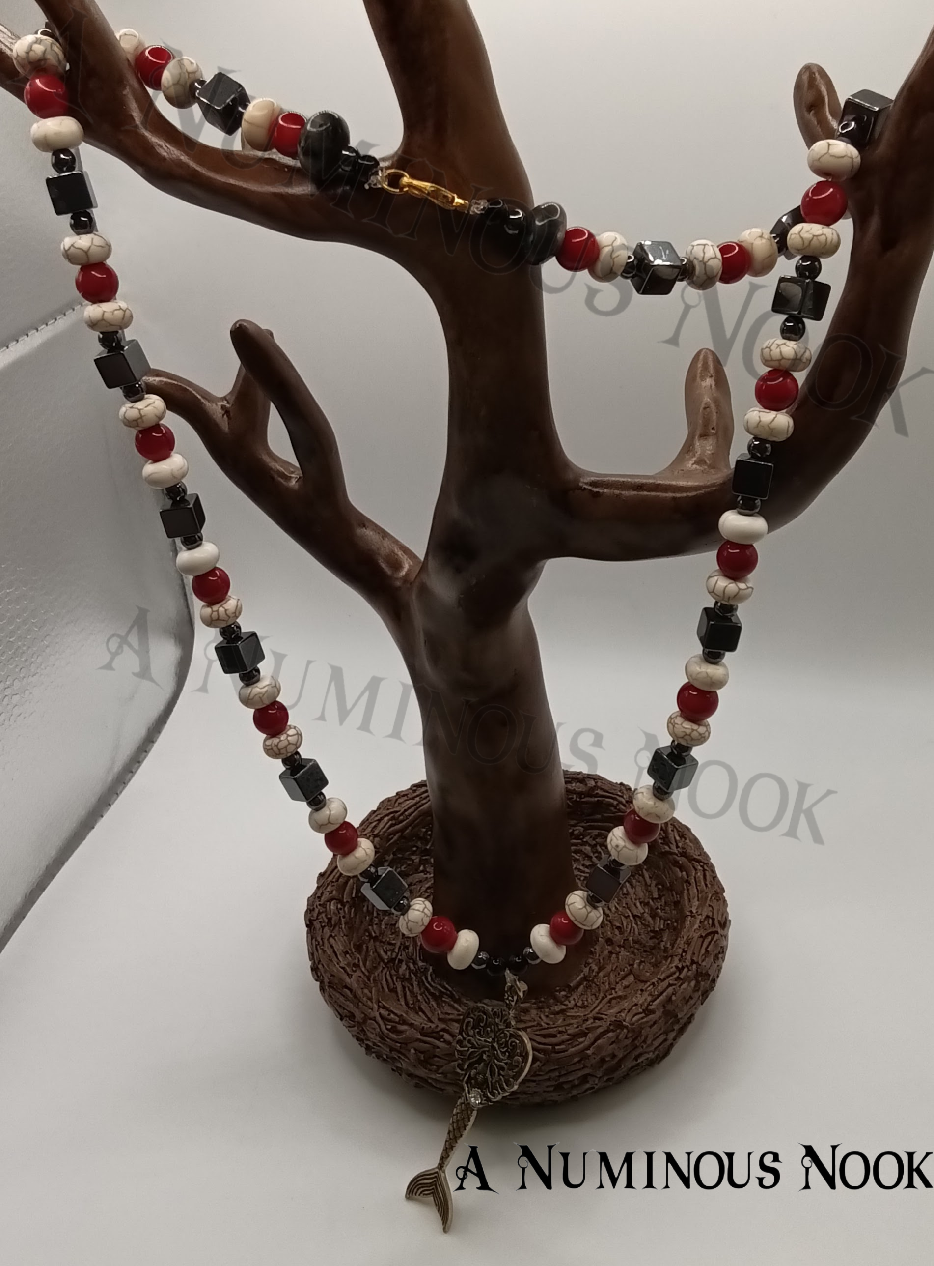 Hematite, red coral, and white howlite mermaid necklace