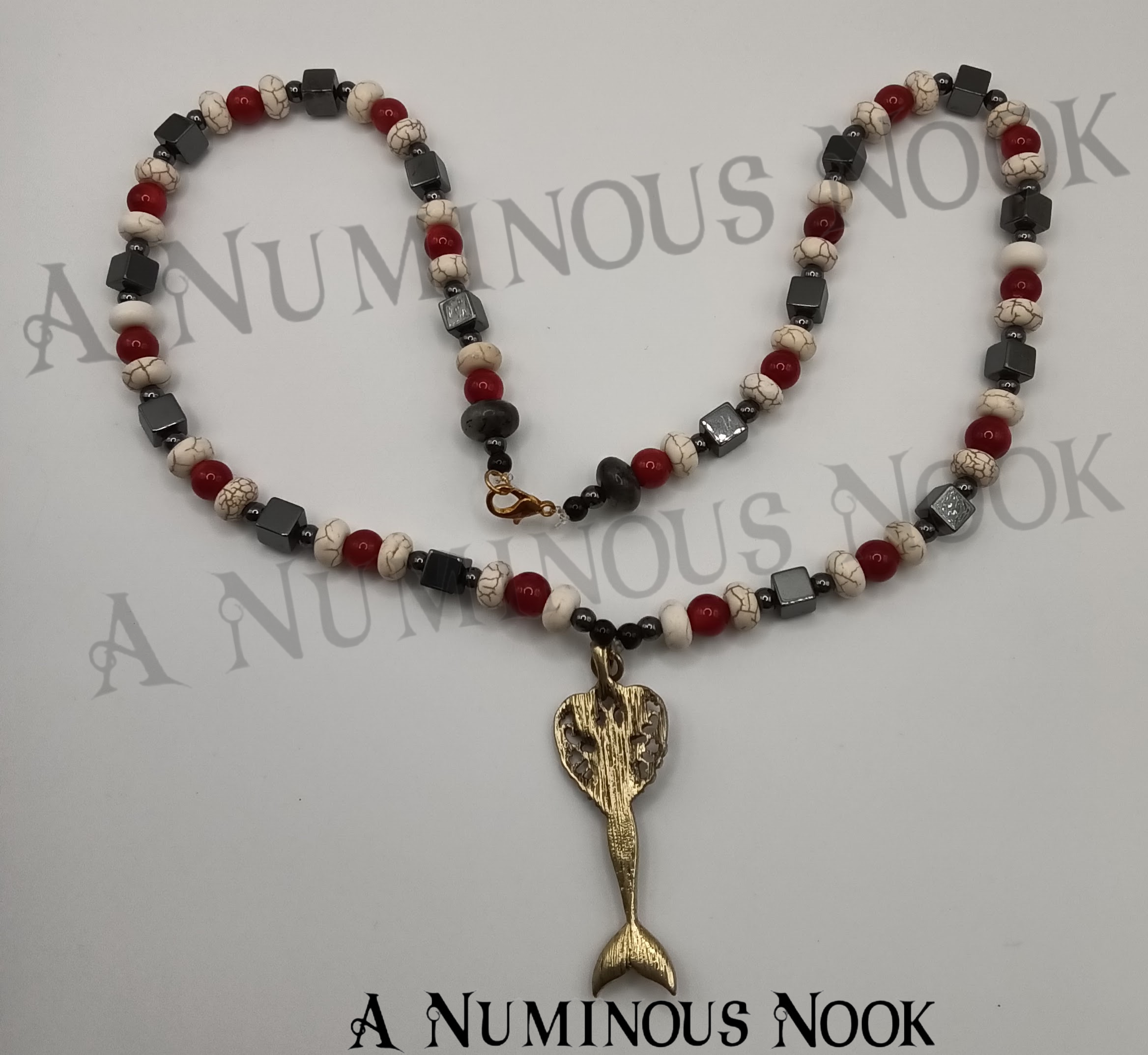 Hematite, red coral, and white howlite mermaid necklace